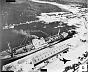 November 6, 1962: Soviet personnel and six missile transporters  loading onto ship transport at Casilda port. (Note shadow at lower right of Capt. Ray Schrecengost piloting the RF-101 Voodoo reconnaissance jet taking the photograph.)